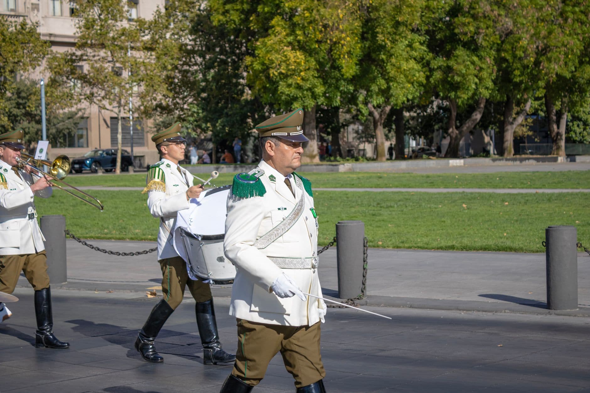 Chilean national police band performing in public parade in Santiago, Chile. Formal uniforms and instruments displayed.