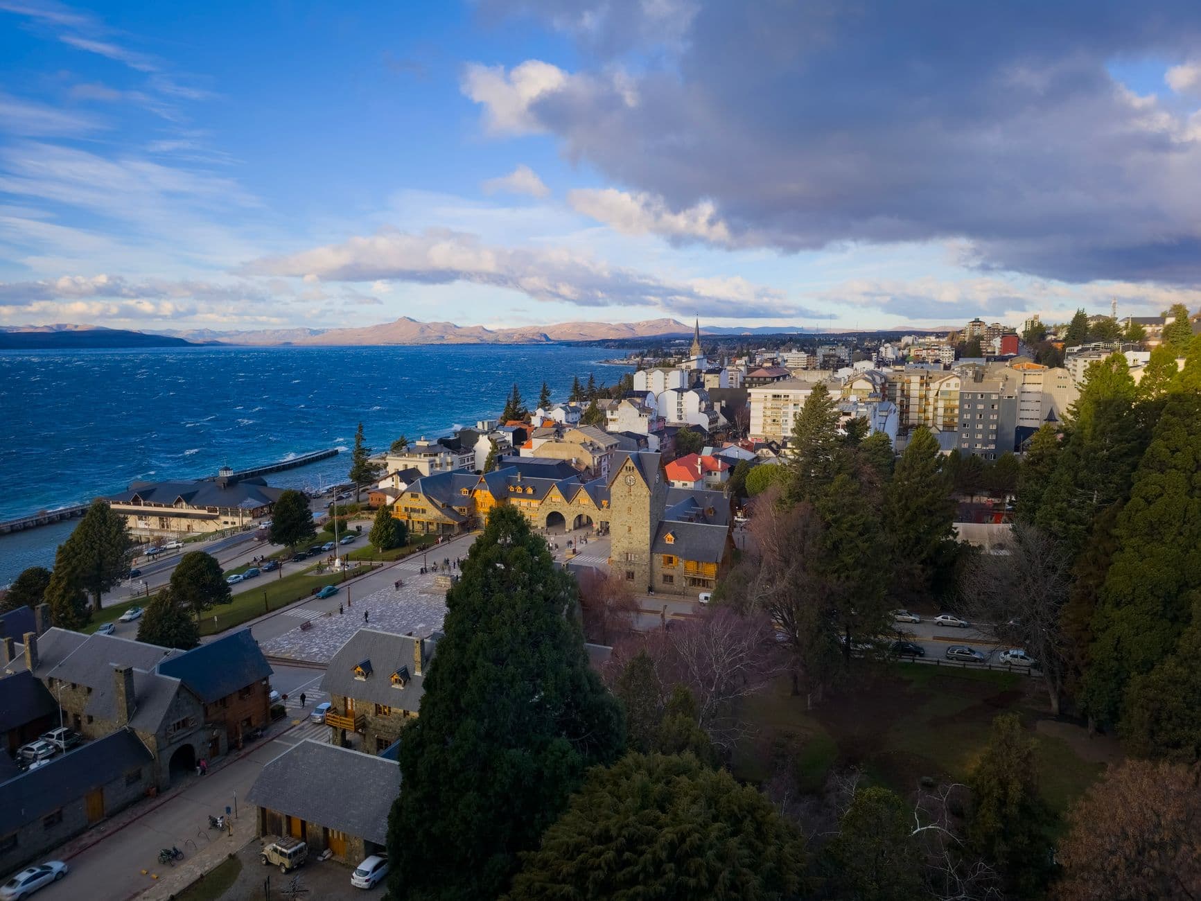 A breathtaking aerial view of San Carlos de Bariloche, capturing the vibrant turquoise lake and charming architecture.