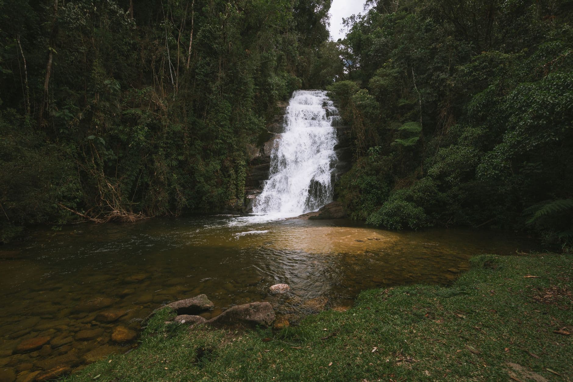 Tranquil waterfall cascading amidst lush greenery in Bananal, Brazil. Perfect nature escape.