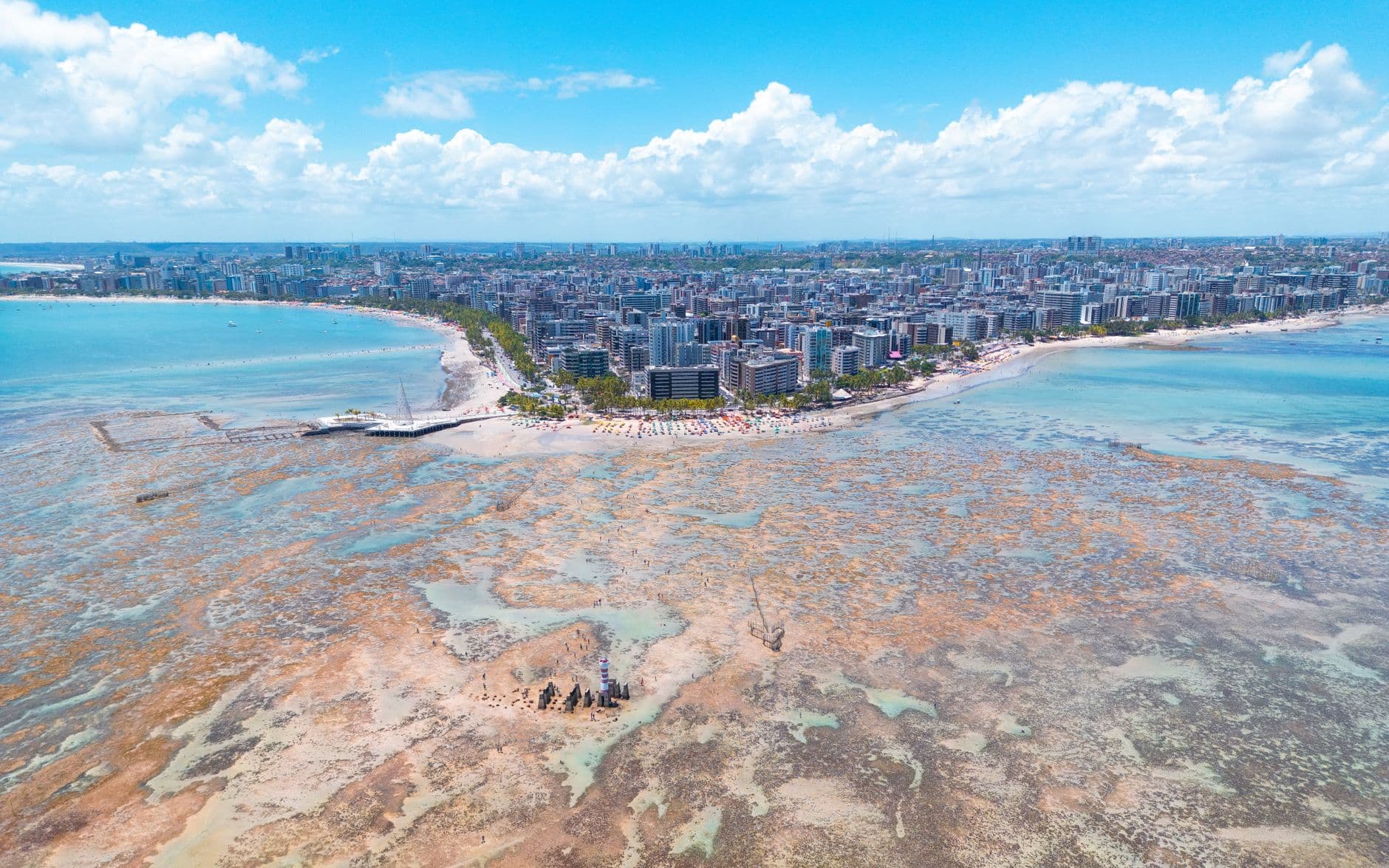 Stunning aerial view of Maceió, Brazil showcasing the vibrant coastline, urban landscape, and turquoise waters.