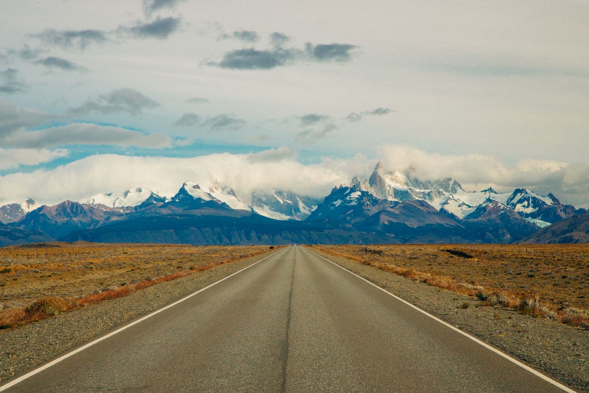 Straight road leading to the snow-capped mountains of El Chaltén, Argentina.