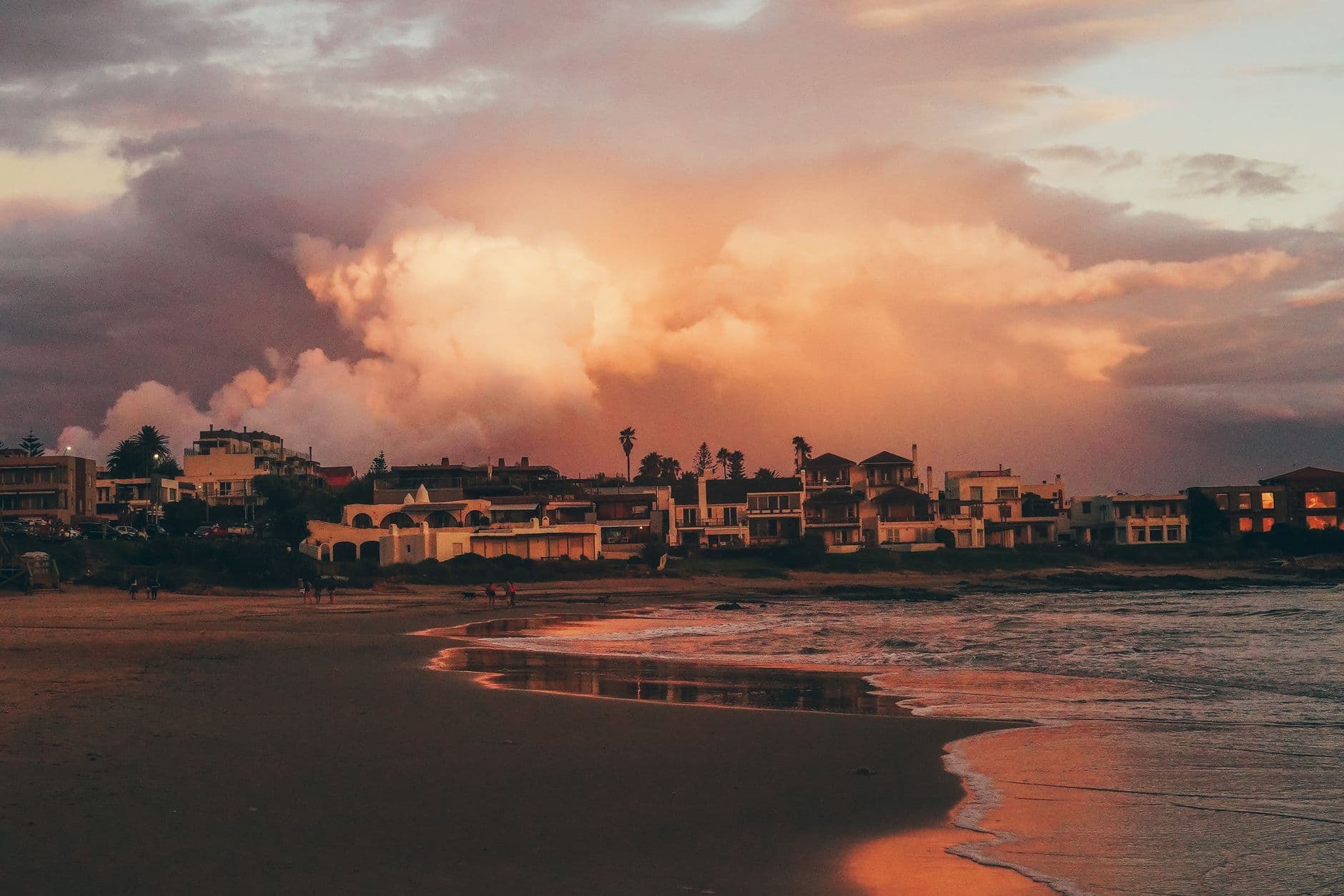 Beautiful sunset over the coastline of Punta del Este, Uruguay, with dramatic clouds and serene waves.