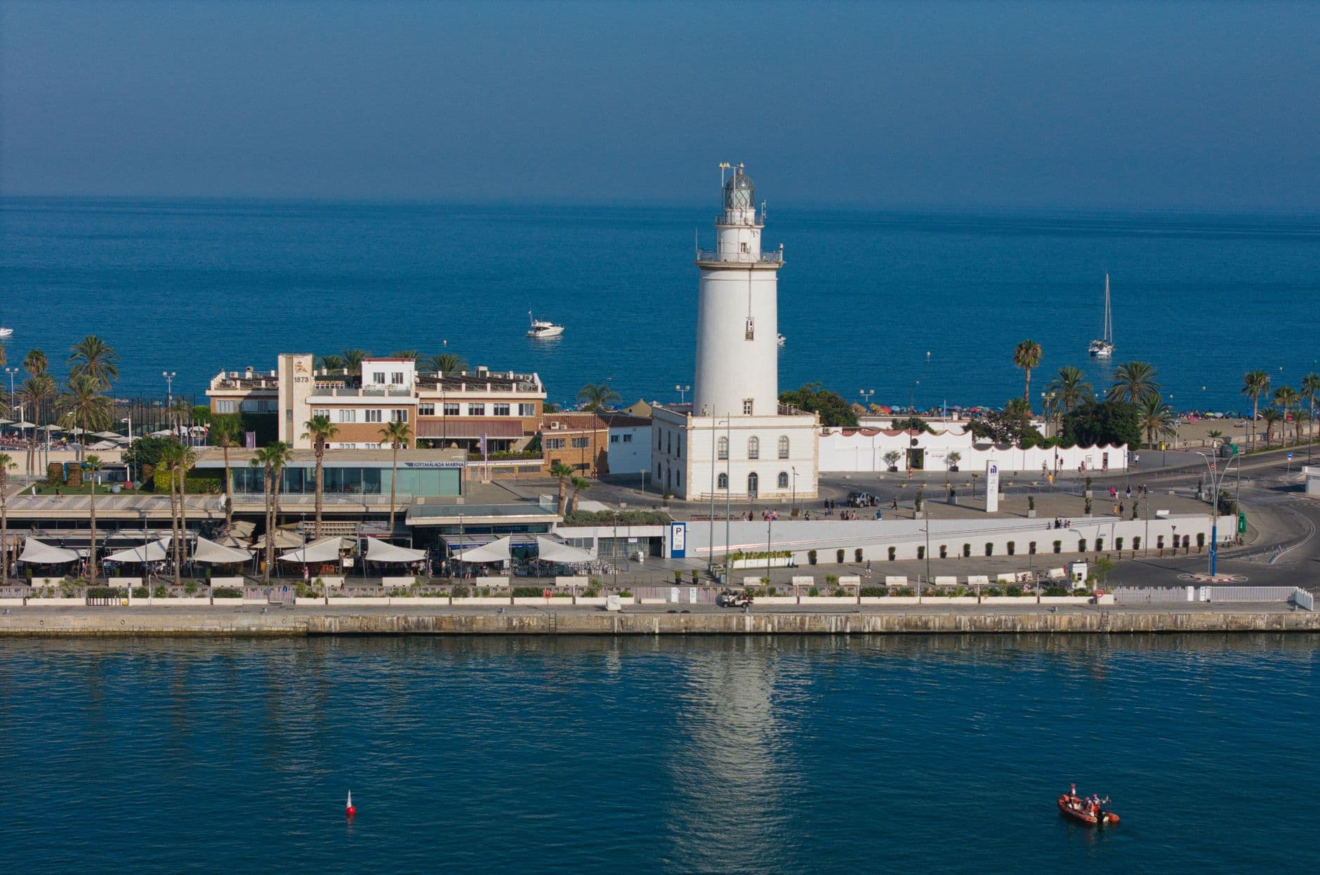 Aerial view of the iconic Malaga Lighthouse by the Mediterranean coast, showcasing architectural beauty and seaside serenity.
