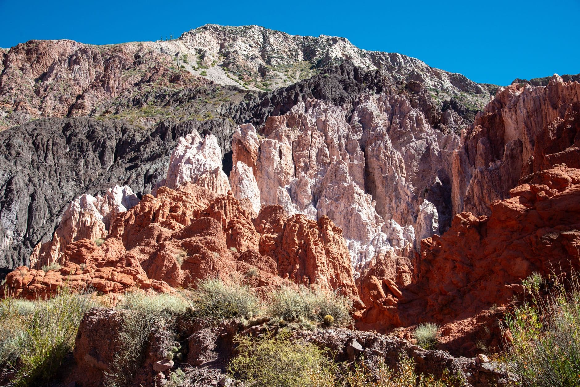 Stunning rock formations under a clear blue sky in Jujuy Province, Argentina.