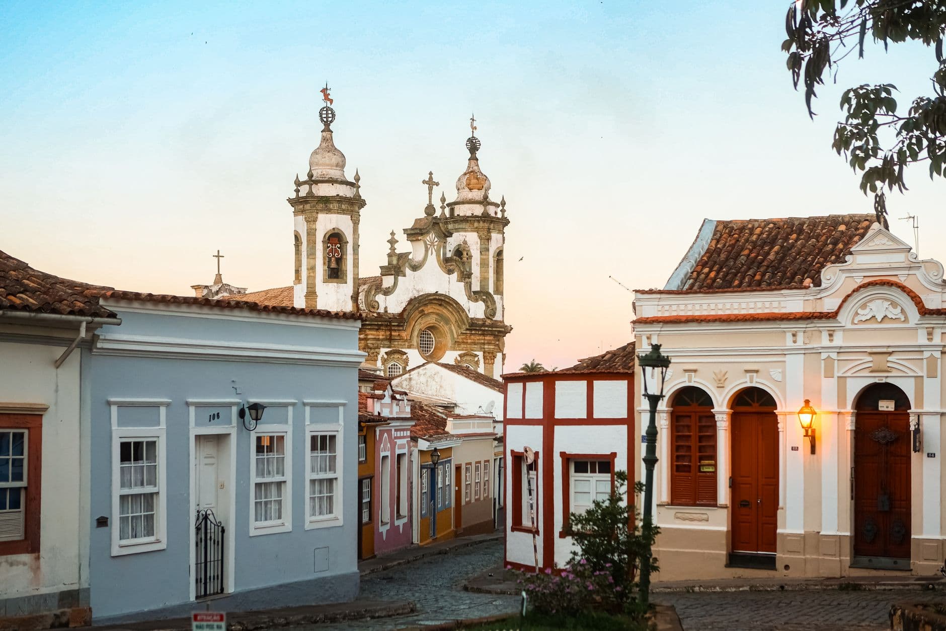 Charming colonial streets of Ouro Preto, Brazil, with historic architecture at sunset.