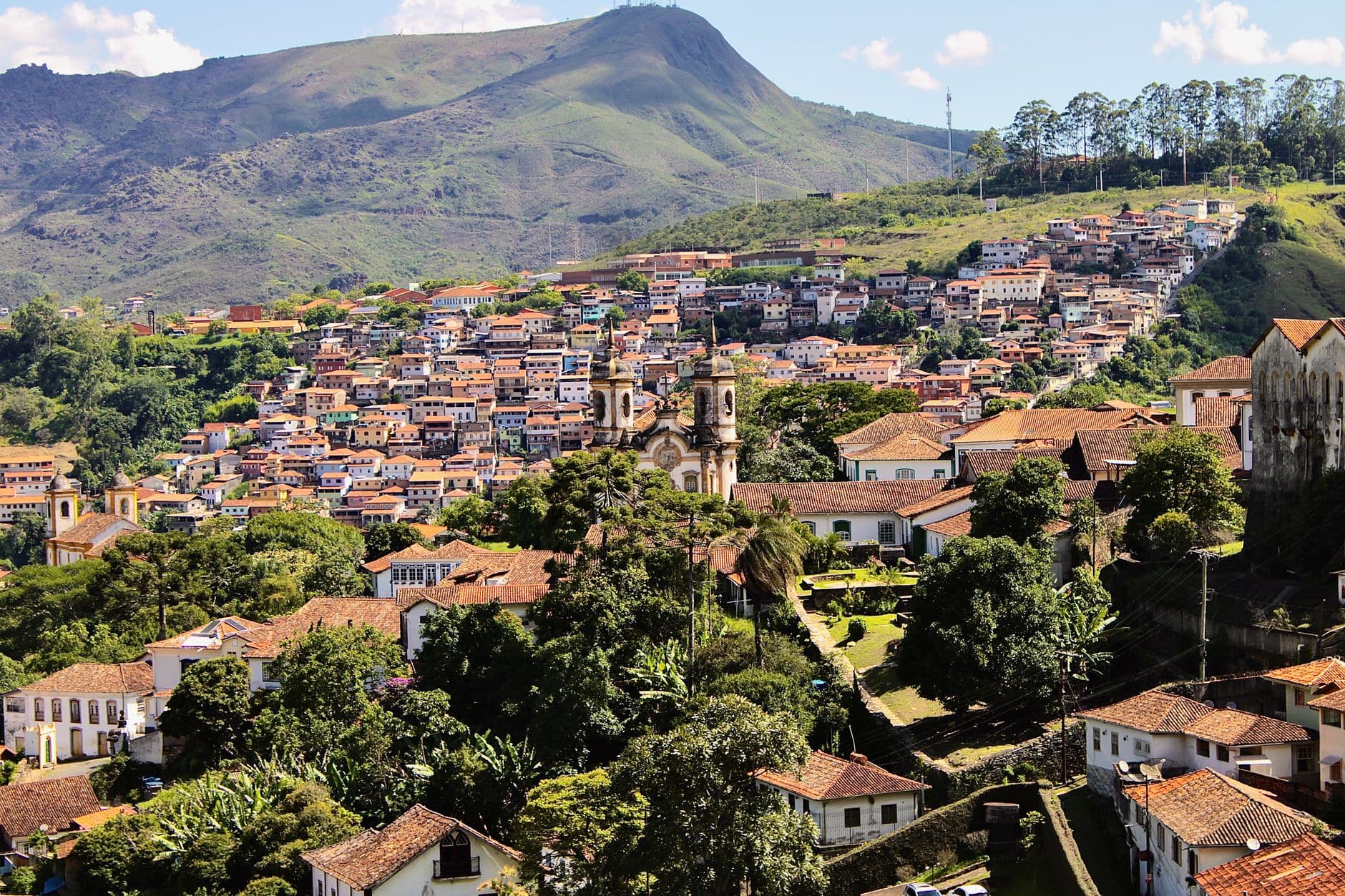 Breathtaking landscape of Ouro Preto, Brazil, with historic architecture nestled in lush hills.