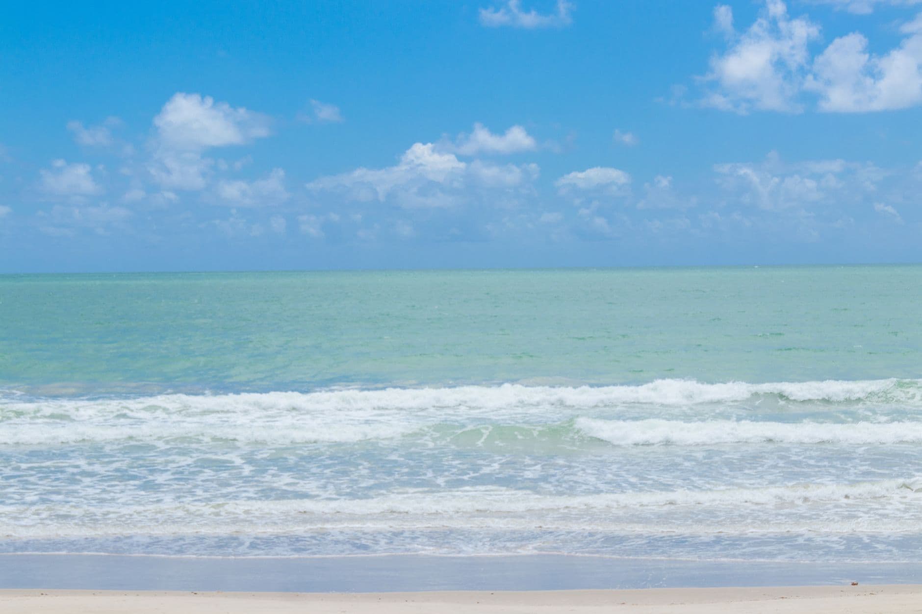 Beautiful view of Praia de Tamandaré's ocean waves and clear sky in Brazil.